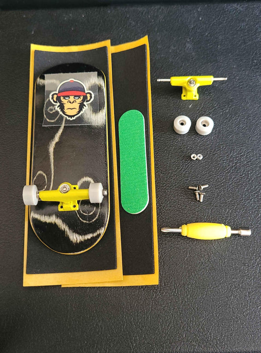 Custom fingerboard kit with monkey graphic deck, yellow trucks, white wheels, and accessories