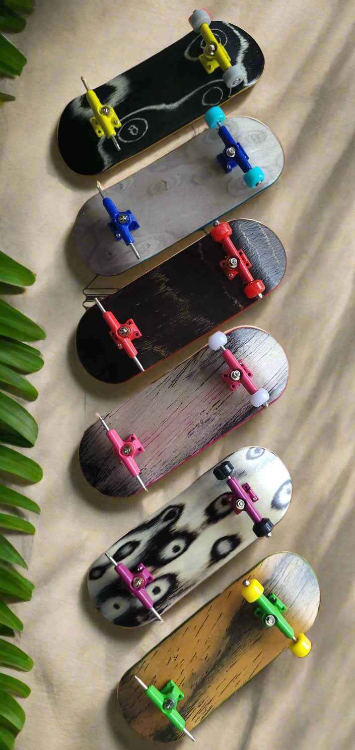 Collection of six custom handmade fingerboard decks with colorful trucks and wheels.
