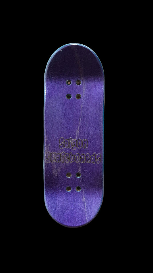 Fingerboard deck, deep purple top with logo text and four mounting holes.