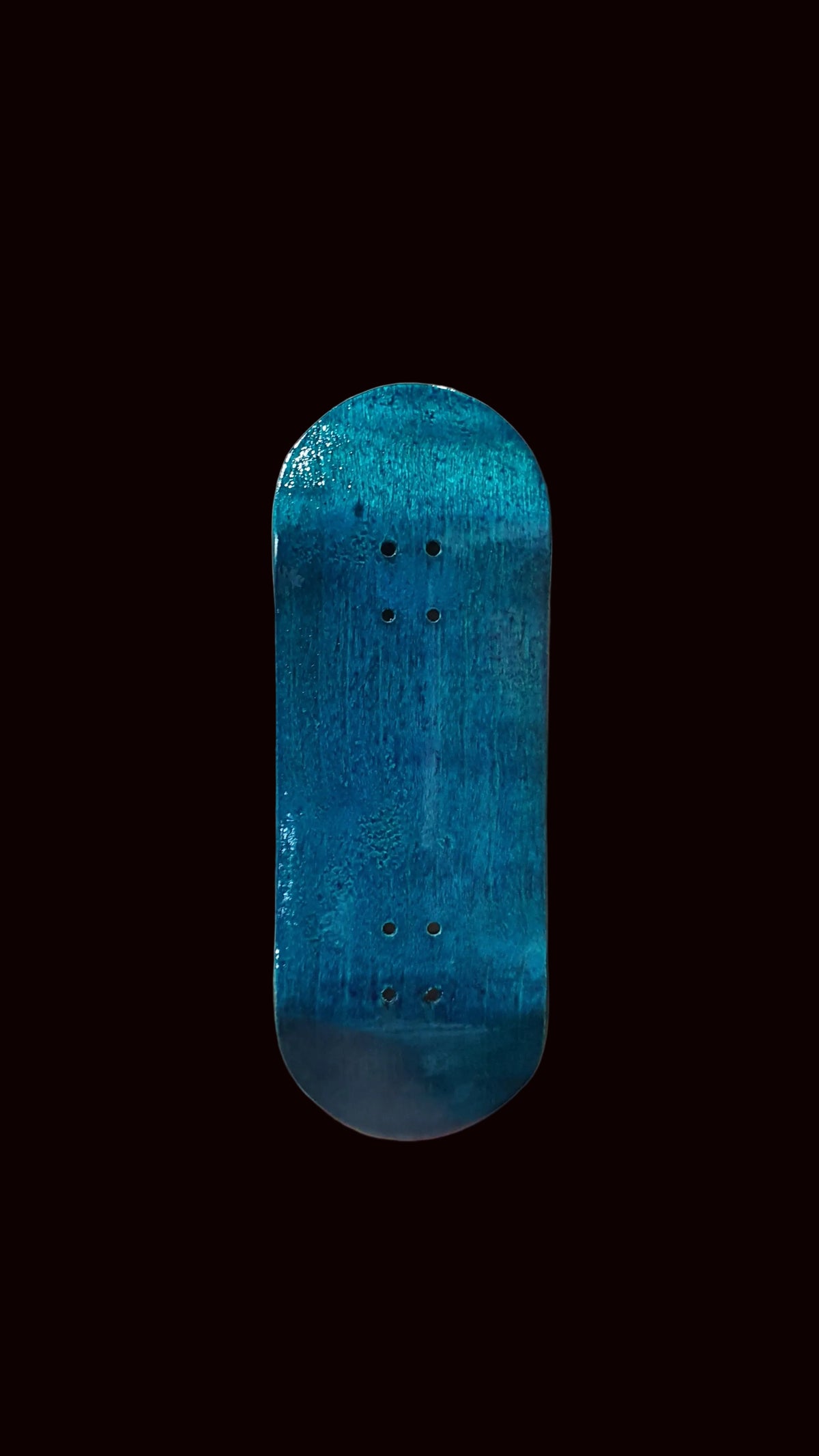 Blue teal fingerboard deck, straight-on view showing mounting holes on top.