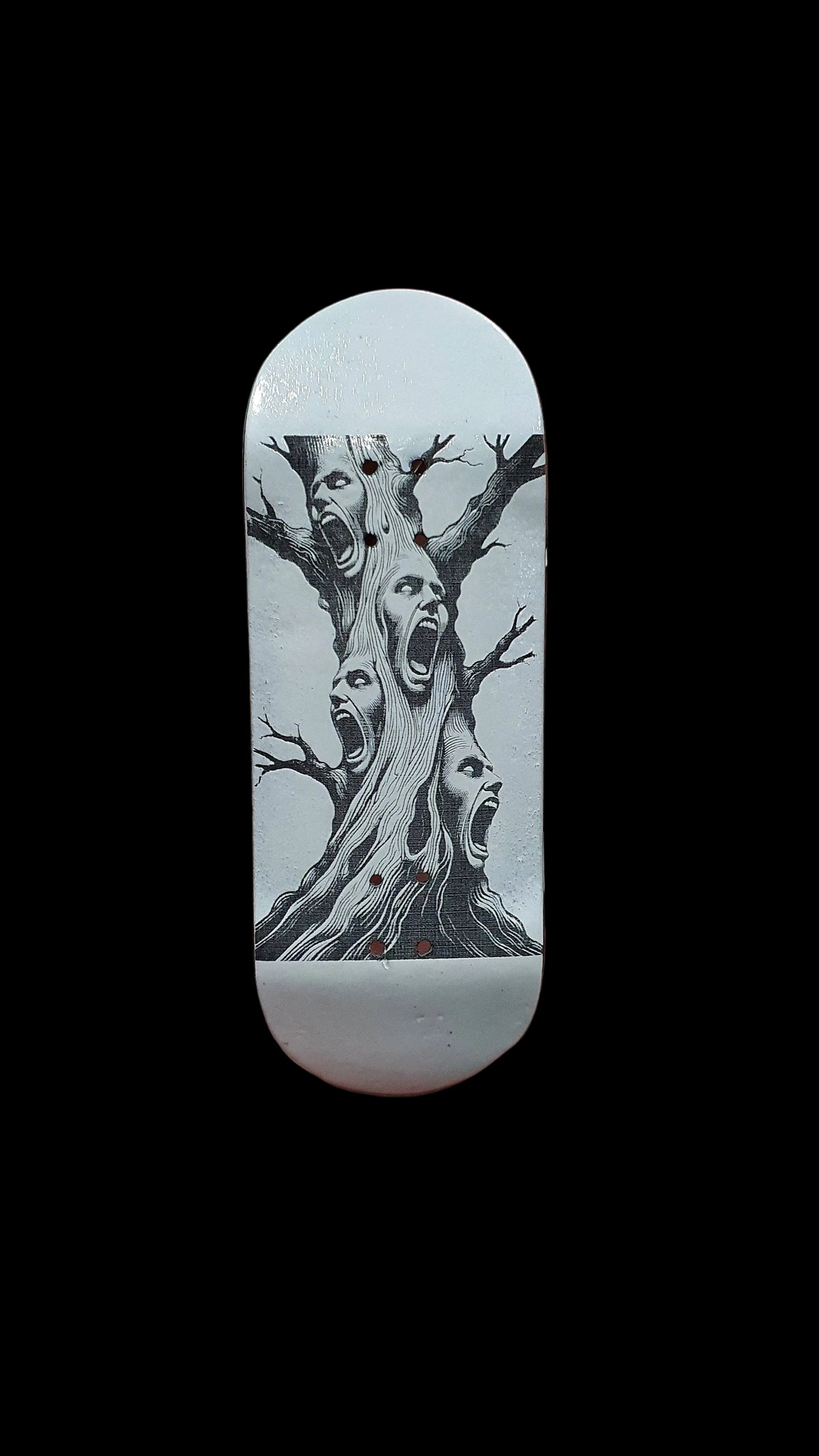 Skateboard deck with tall tree-face illustration in black on white base