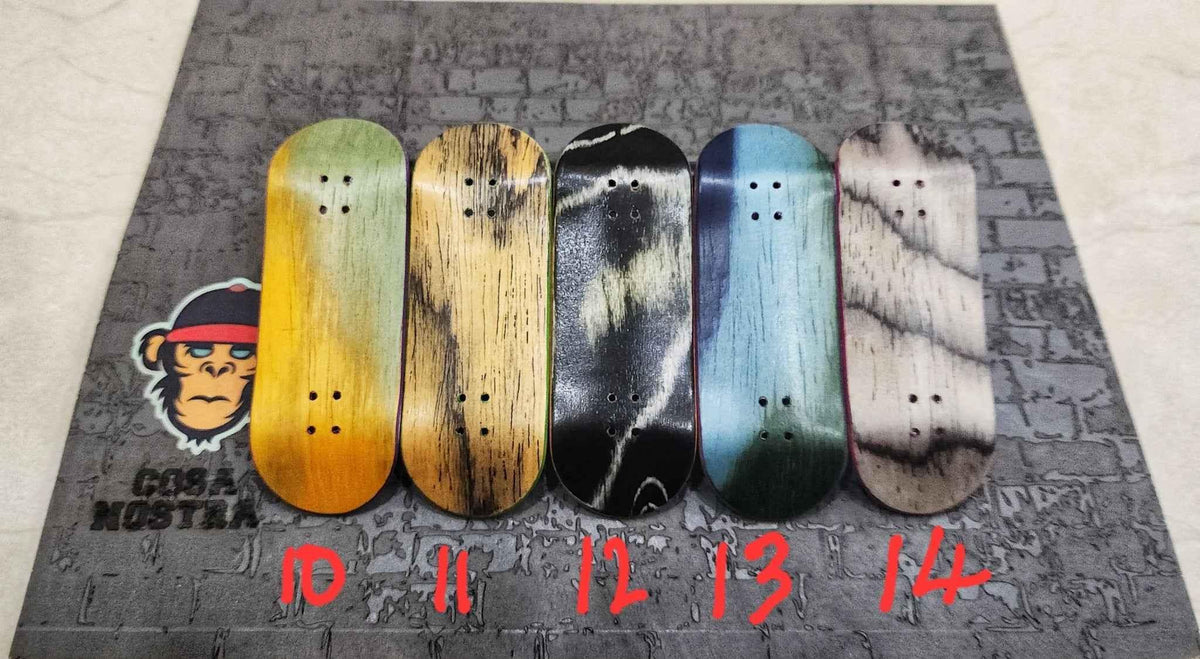 Five custom handmade fingerboard decks with different wood grain patterns.