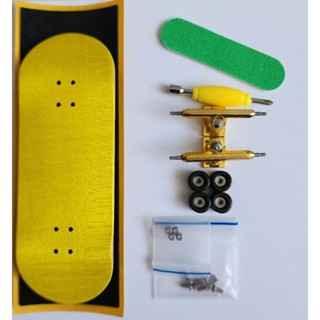 Fingerboard kit with a yellow deck, gold trucks, black wheels, and green grip tape.