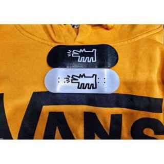 Black and white custom handmade fingerboard decks on a yellow hoodie.
