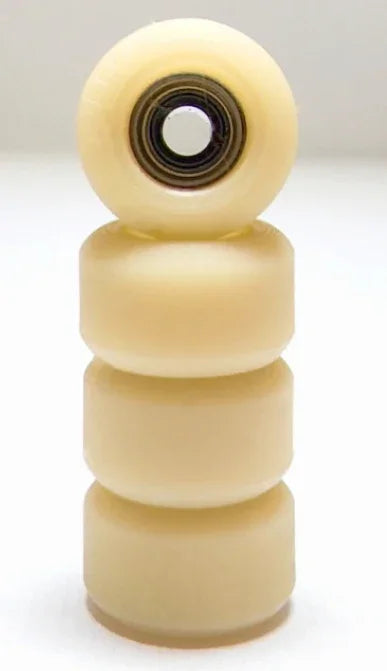 Set of four cream-colored custom fingerboard wheels with a metal bearing.