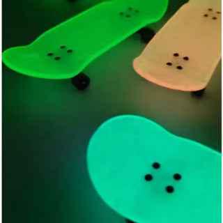 Glow-in-the-dark green and cream colored fingerboard decks