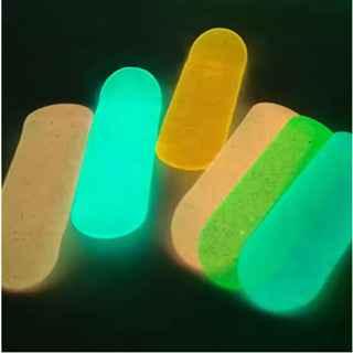 Five glowing neon fingerboard decks in various colors against a dark background