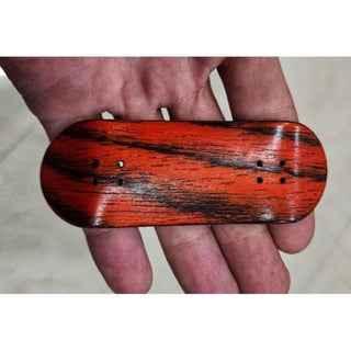 Handmade custom wood fingerboard deck with red and black grain pattern