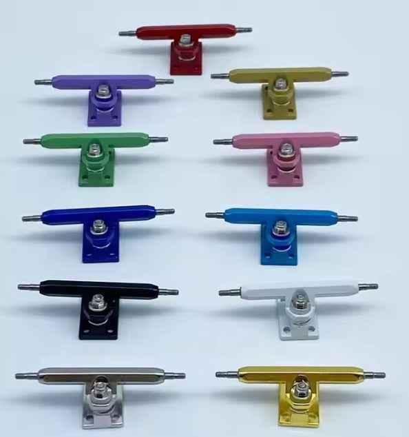 Assorted colorful fingerboard trucks in various metallic and matte finishes.