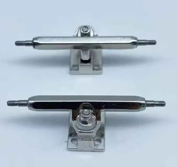 Two silver metal fingerboard trucks for custom fingerboard decks.