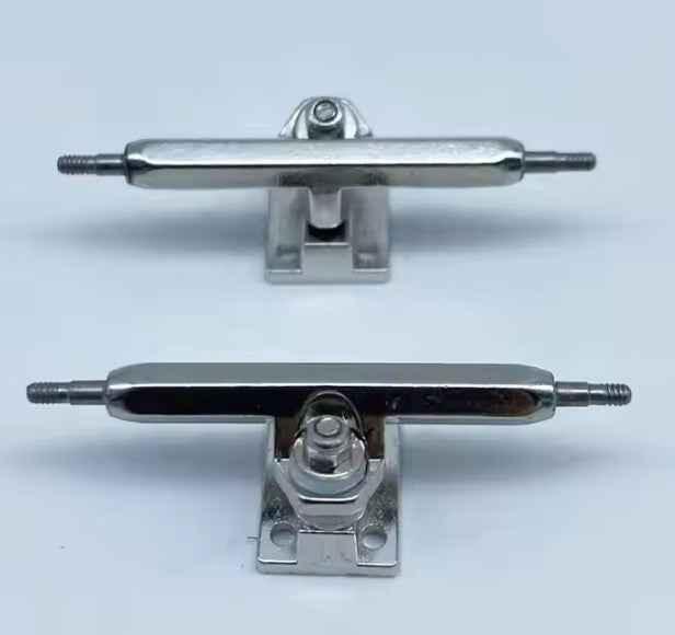 Two miniature metal fingerboard trucks for custom fingerboard builds