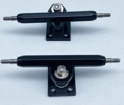 Two black miniature fingerboard trucks for custom fingerboard builds.