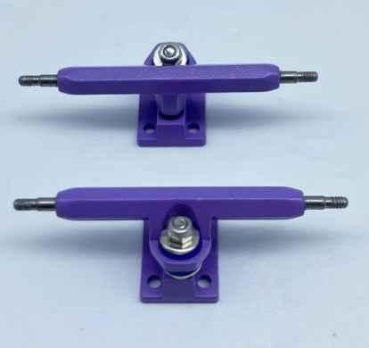 Pair of purple custom fingerboard trucks for miniature skateboards.