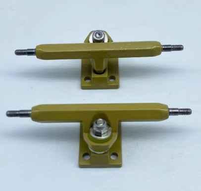 Two olive green custom fingerboard trucks on a white background.