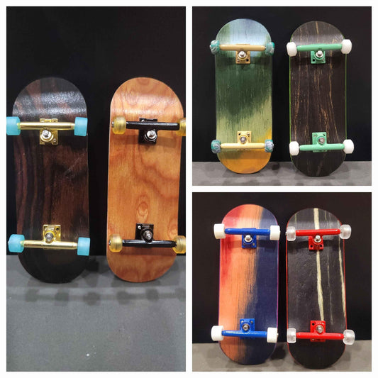 Collection of six handmade wooden fingerboard decks with various colored trucks and wheels.