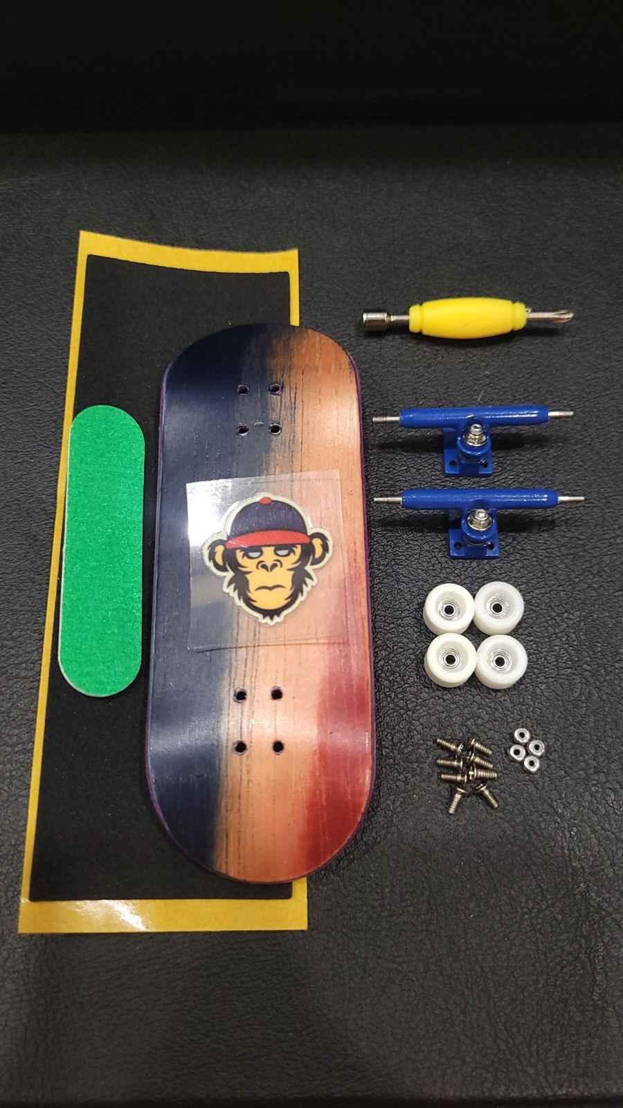 Custom fingerboard kit with a monkey graphic deck, blue trucks, white wheels, and accessories.