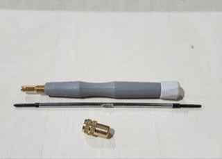 Fingerboard tool kit with grey handle, metal rod, and brass accessory on white background