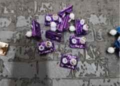 Purple custom fingerboard trucks and hardware on a textured grey background