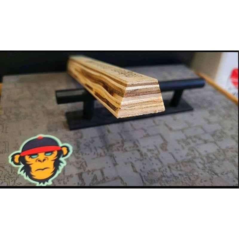 Handmade custom wood fingerboard deck resting on a black display stand