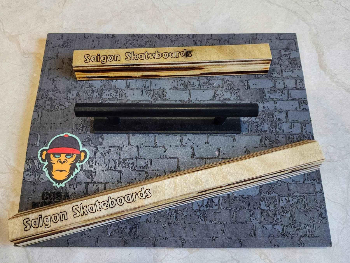 Handmade wooden fingerboard rails and a black metal rail on a brick-patterned background