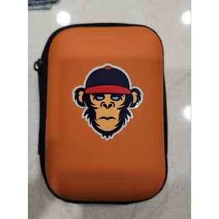Orange fingerboard carrying case with a monkey wearing a cap graphic
