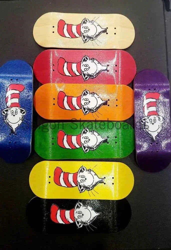 Collection of colorful handmade fingerboard decks featuring Cat in the Hat illustrations.