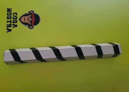 A black and white striped fingerboard rail on a lime green background.