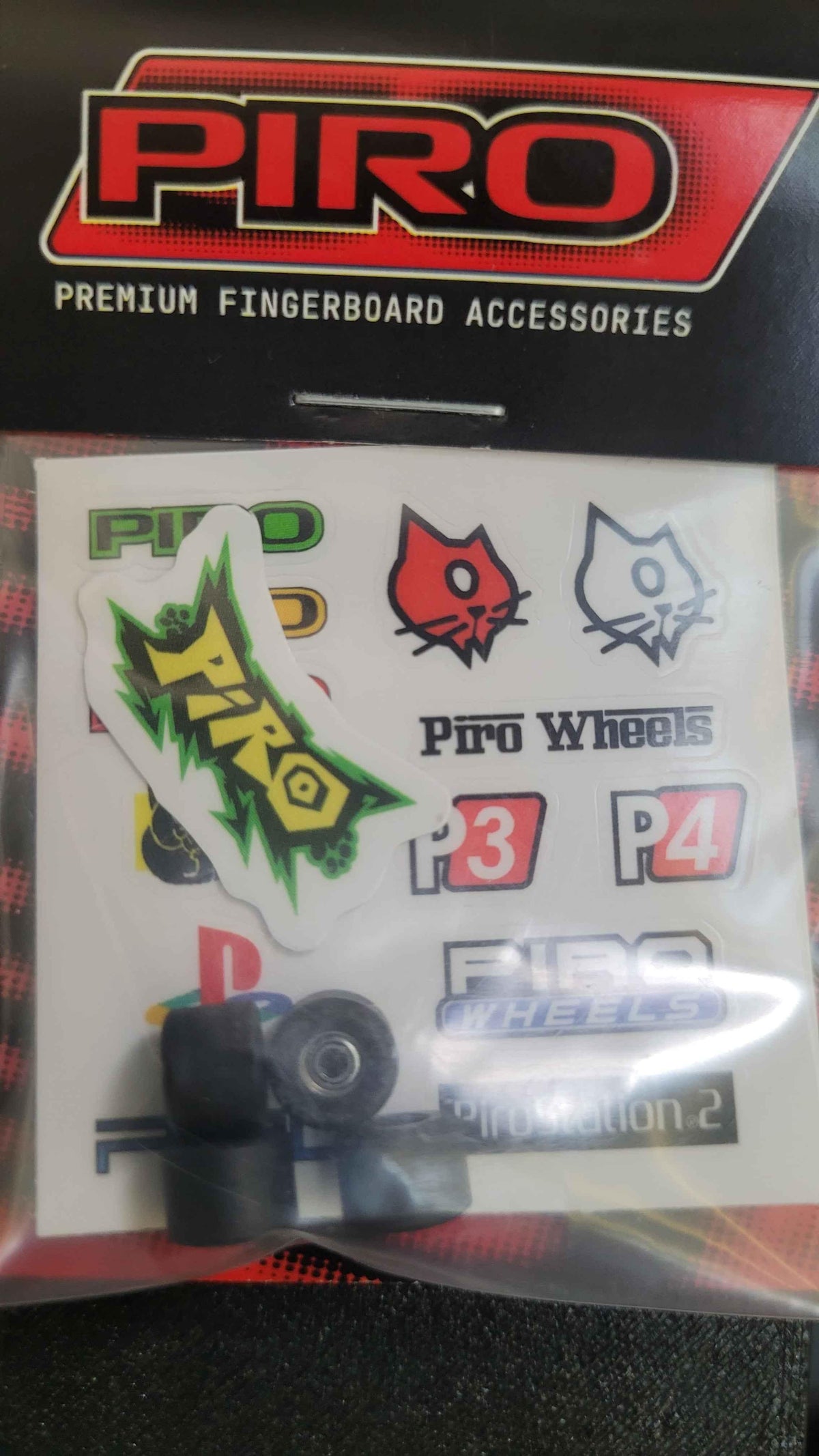 Piro brand fingerboard accessory sticker pack and black fingerboard wheels.