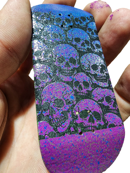 Handmade custom fingerboard deck with purple and blue skull pattern graphics.