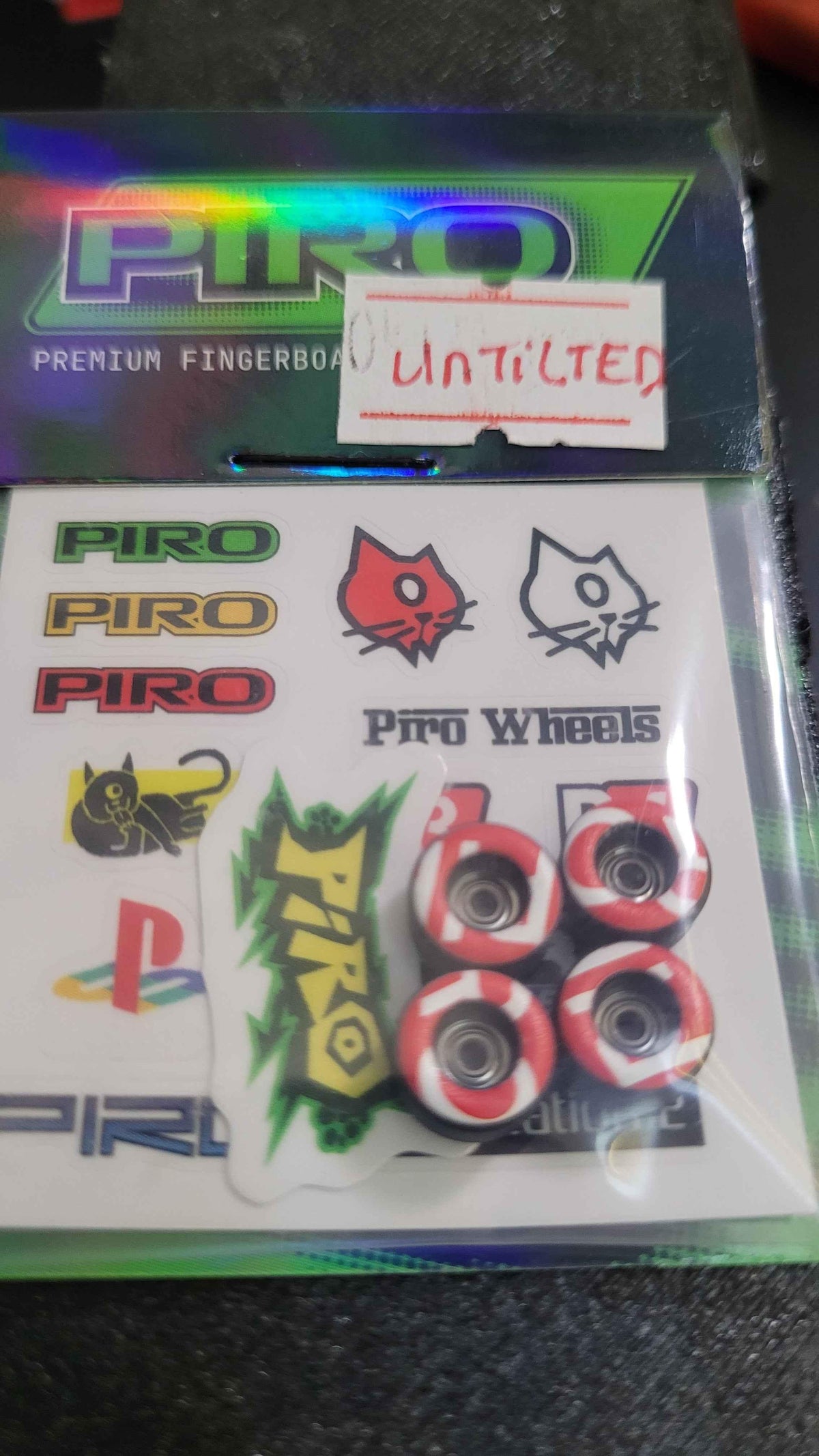 Piro brand fingerboard sticker pack with logo decals and miniature fingerboard wheels.