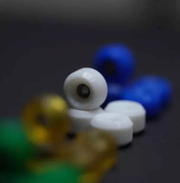 Close-up of colorful professional fingerboard wheels in white and blue