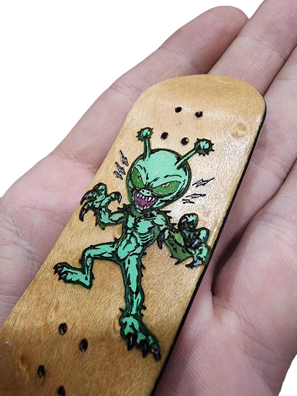 Handmade wooden fingerboard deck featuring a green alien monster illustration.