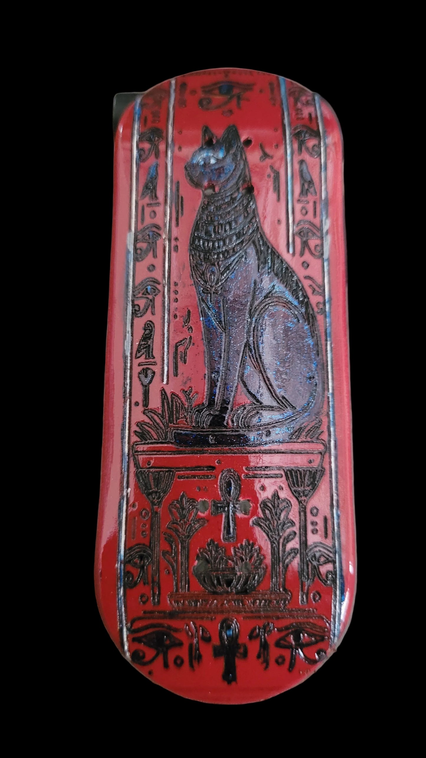 Decorative red box with black designs on a textured surface