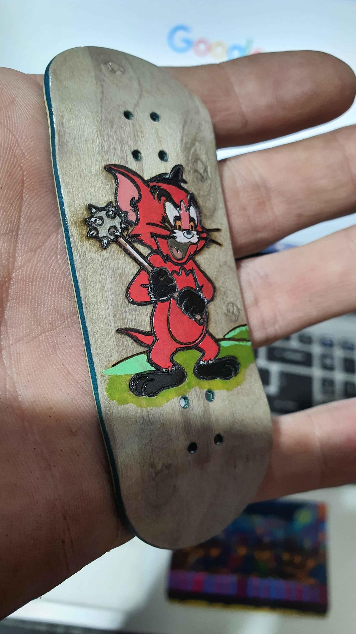 Saigon Skateboard Mace fingerboard deck, angled view of graphic