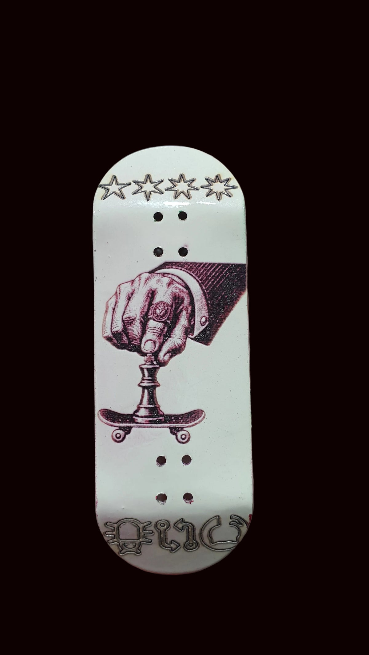 White fingerboard deck with purple boxing-hand graphic, stars at top, and bottom script