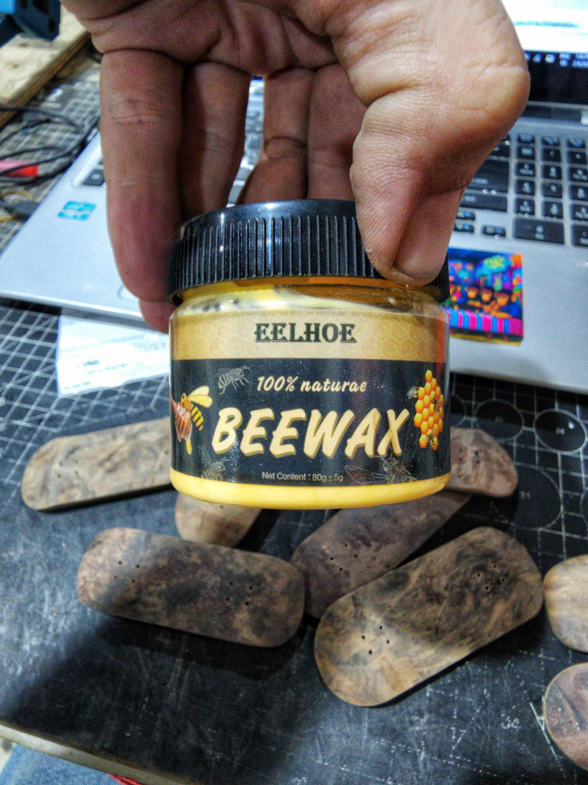 EELHOE 100% natural beeswax jar for fingerboard tricks on a workspace.