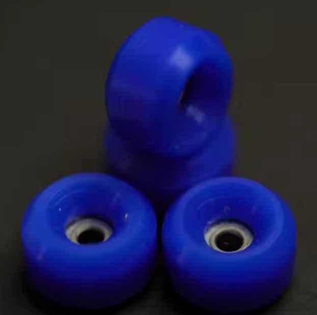 Set of blue fingerboard wheels on a dark background