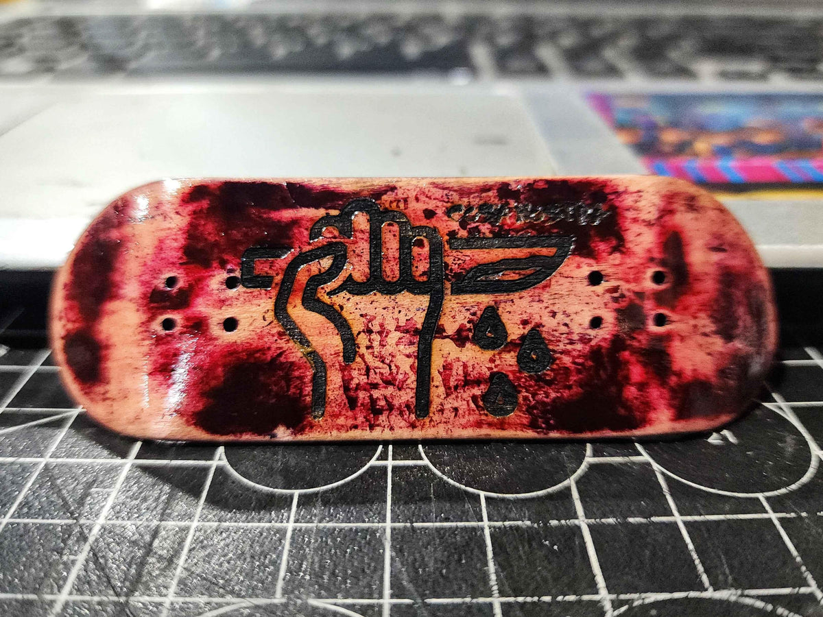 Custom handmade fingerboard deck with blood splatter art and a black graphic illustration