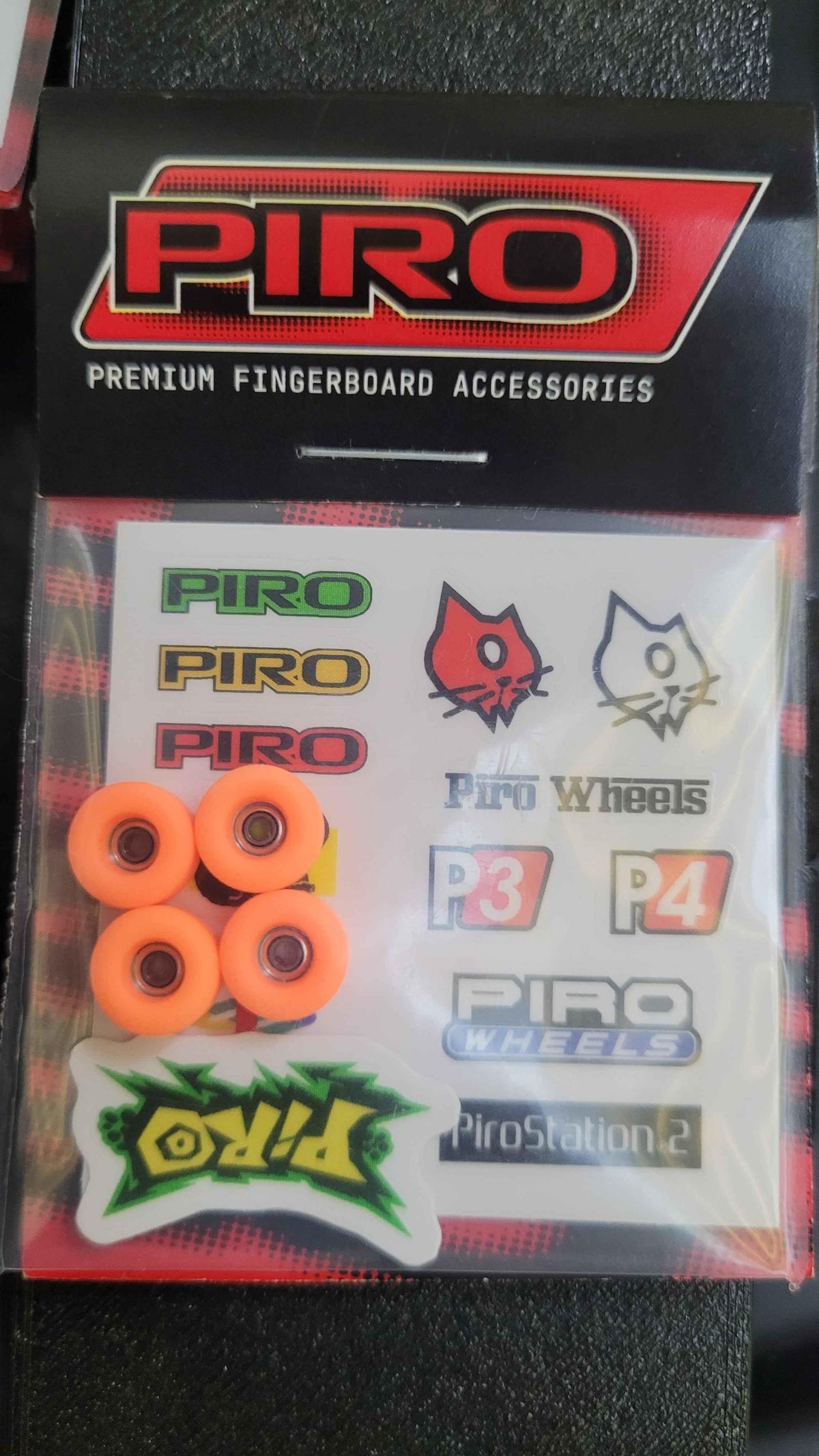 Piro premium fingerboard accessories kit with orange wheels and brand stickers.