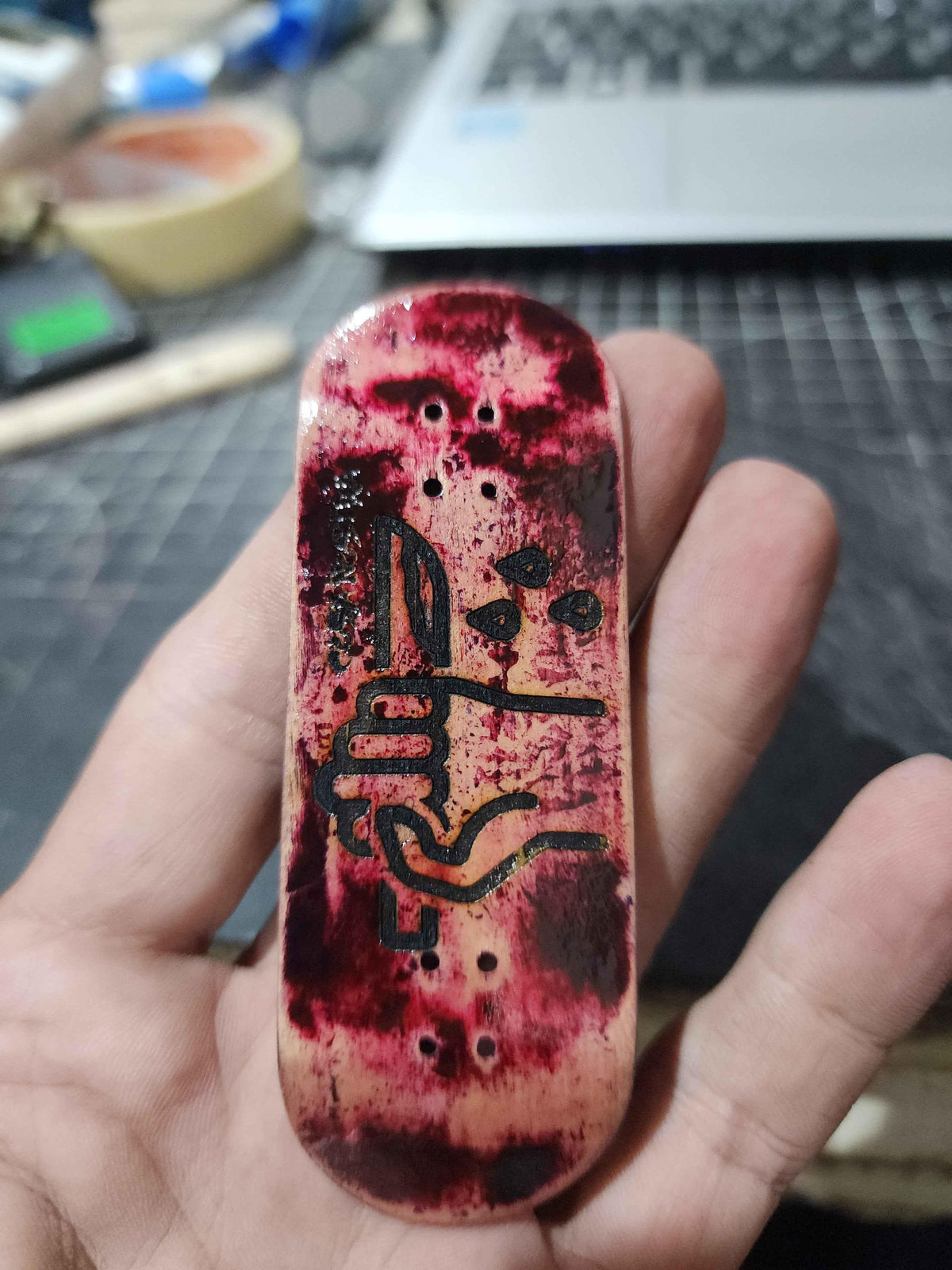 Hand-painted custom fingerboard deck with red splatter and black abstract art design