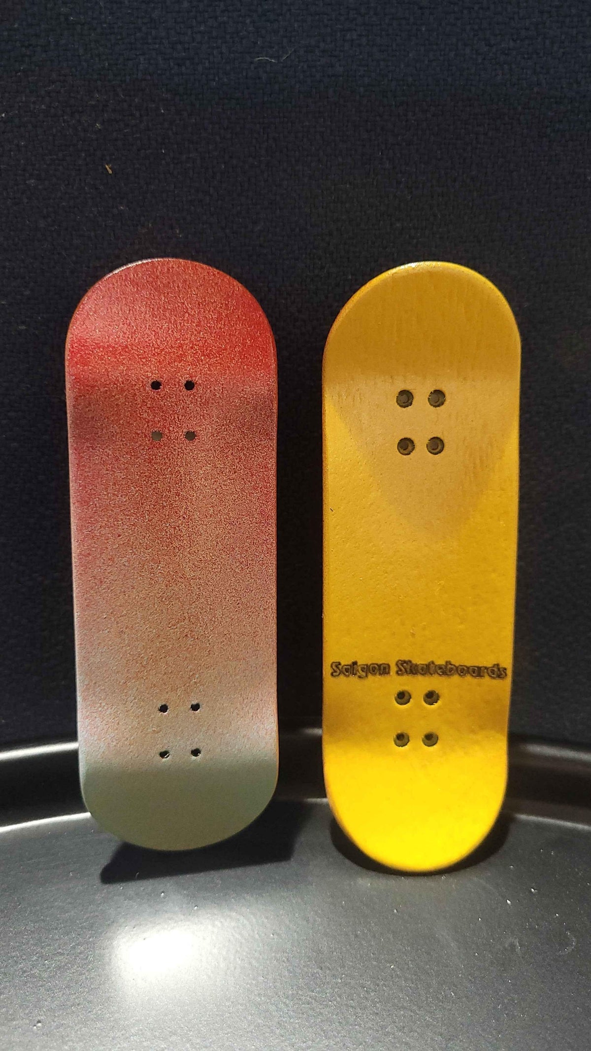 Red and yellow gradient handmade custom fingerboard decks for miniature skateboarding.