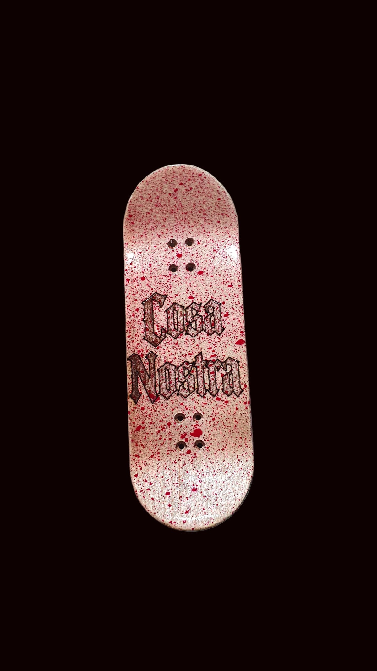 Popsicle fingerboard deck, pink speckled finish with black text graphic and mounting holes