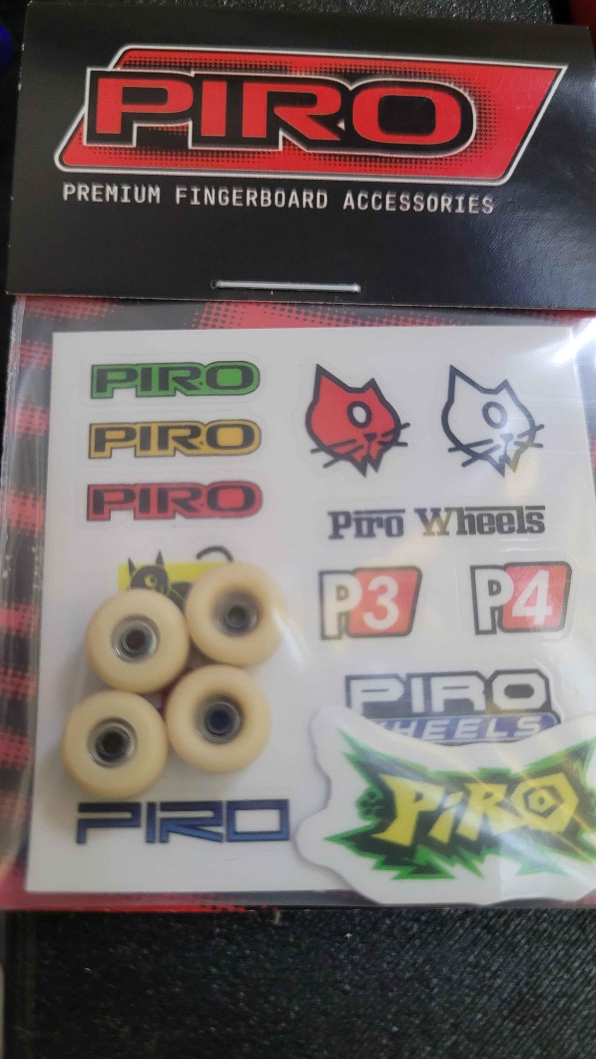 Piro premium fingerboard accessories set featuring small wheels and branded stickers.