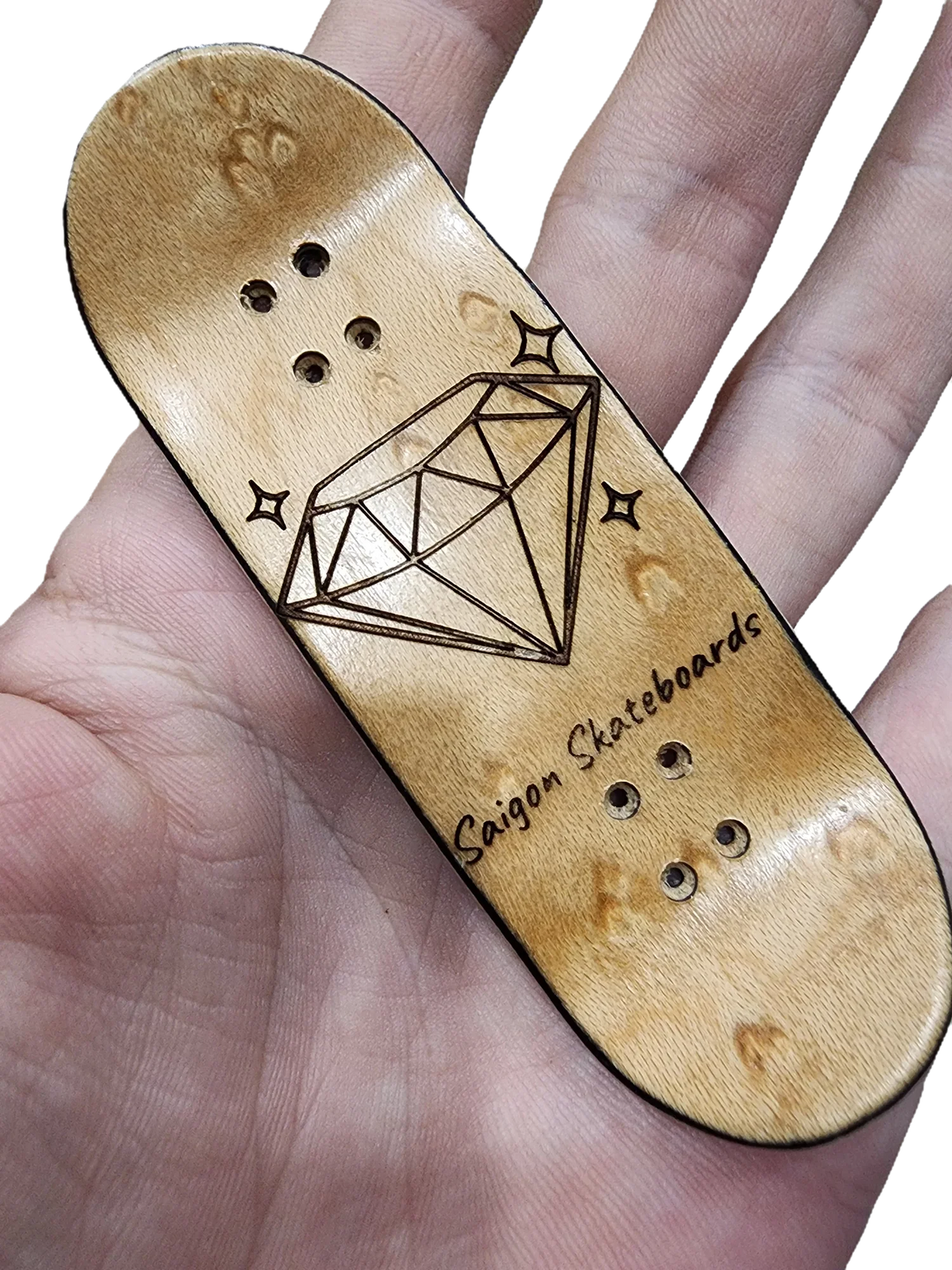 Handmade wooden fingerboard deck with a diamond engraving and Saigon Skateboards text.