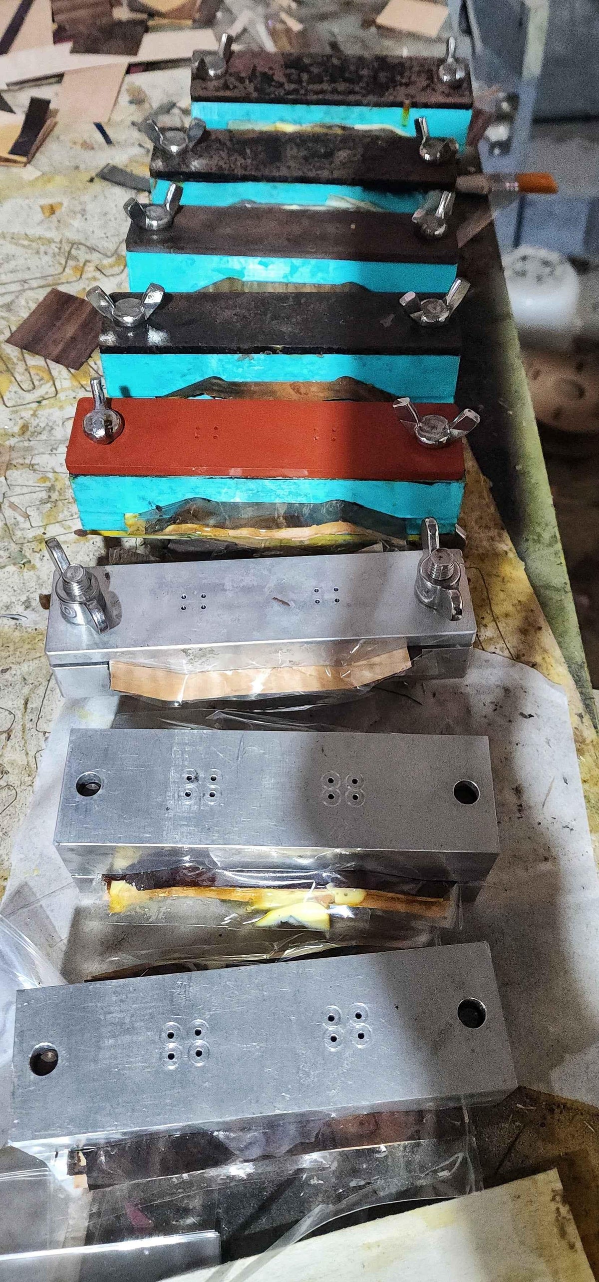 Metal and wooden molds used for manufacturing handmade custom fingerboard decks.