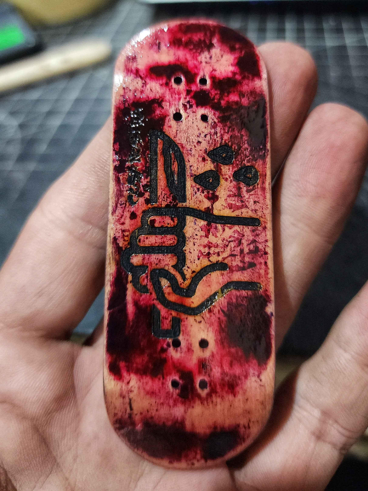 Handmade custom fingerboard deck with red blood splatter art and black graphics