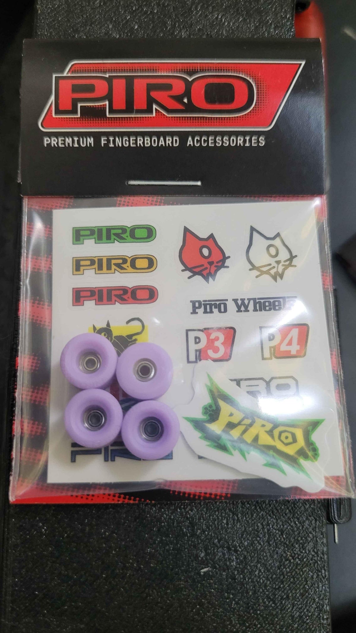 Piro premium fingerboard wheels set with purple wheels and brand stickers.