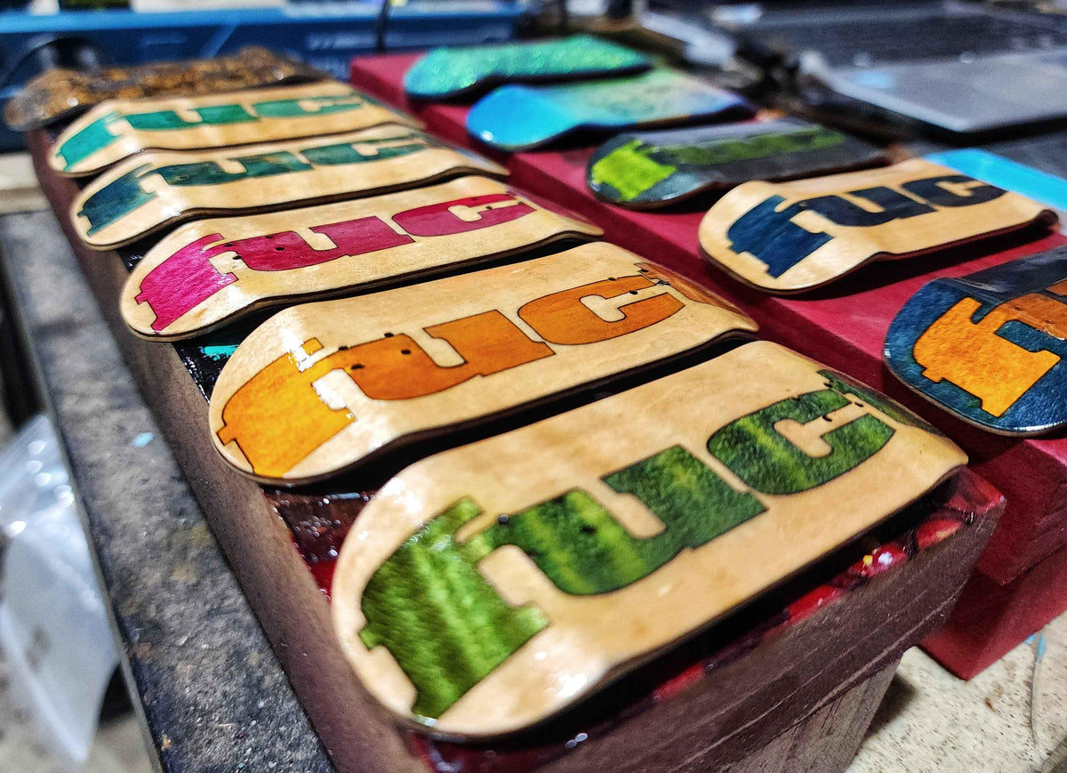 Collection of custom handmade fingerboard decks with colorful graphic prints