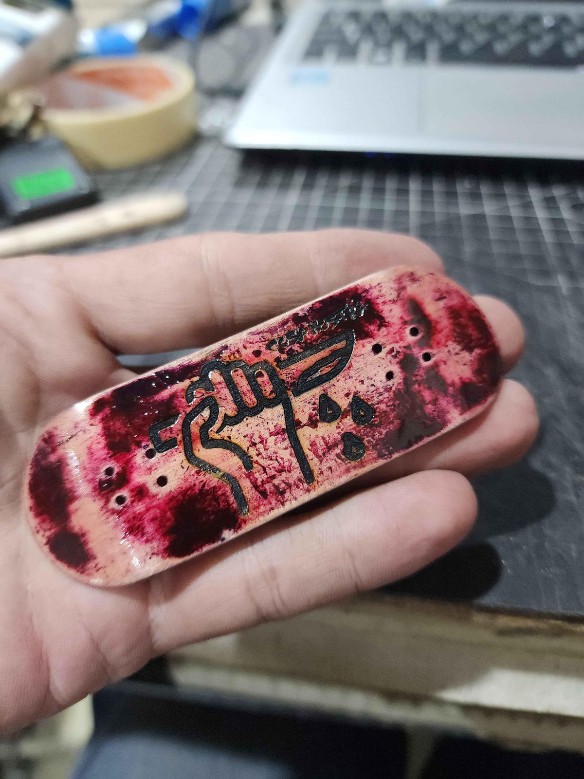 Custom handmade fingerboard deck with red and black blood-splatter art and hand graphic.