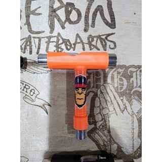 Orange custom fingerboard truck with character graphic detail.